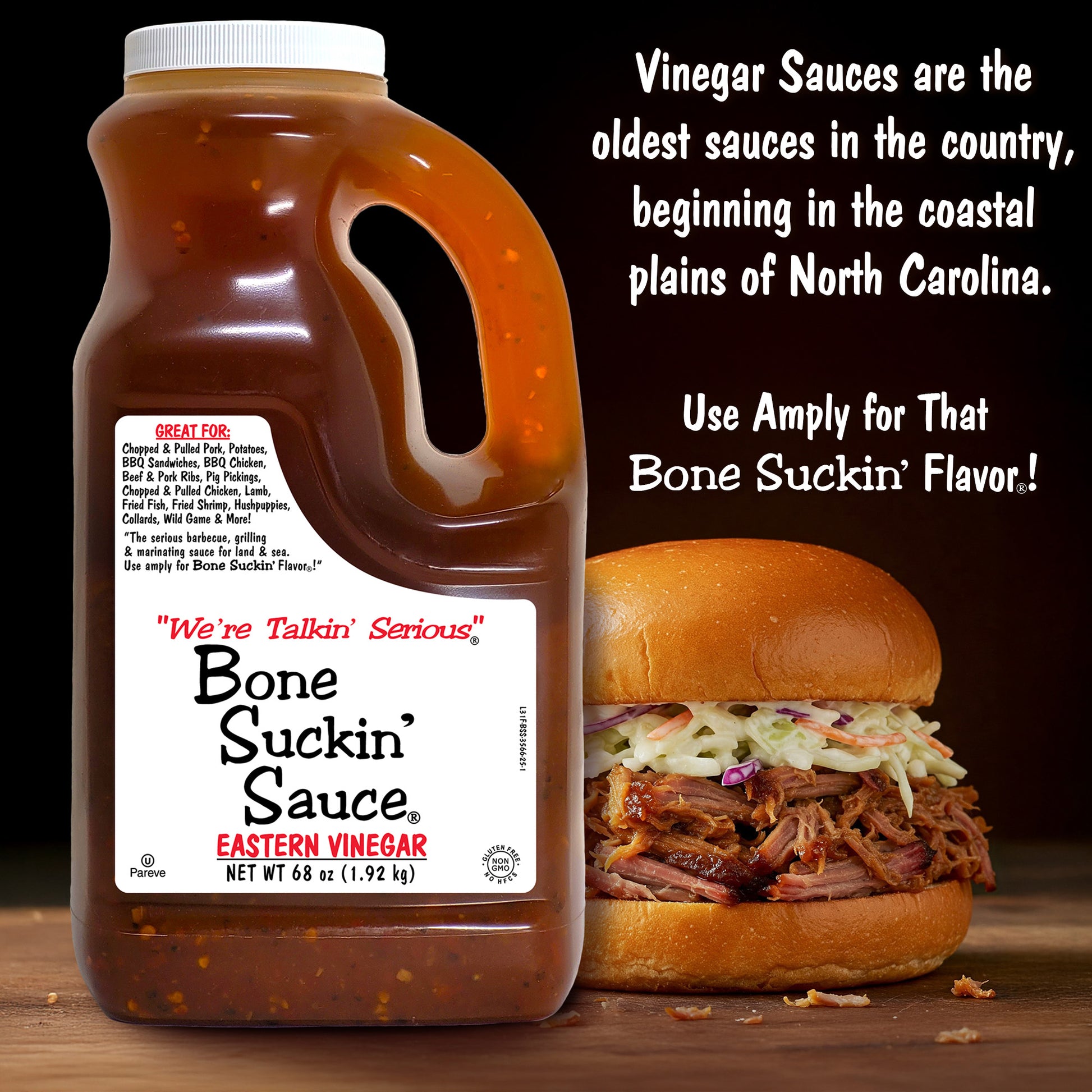 Bone Suckin' Sauce Eastern Vinegar Jar with a pulled pork sandwich on a wooden surface. - "Vinegar Sauces are the oldest sauces in the country, beginning in the coastal plains of North Carolina. Use amply for that Bone Suckin' Flavor!"