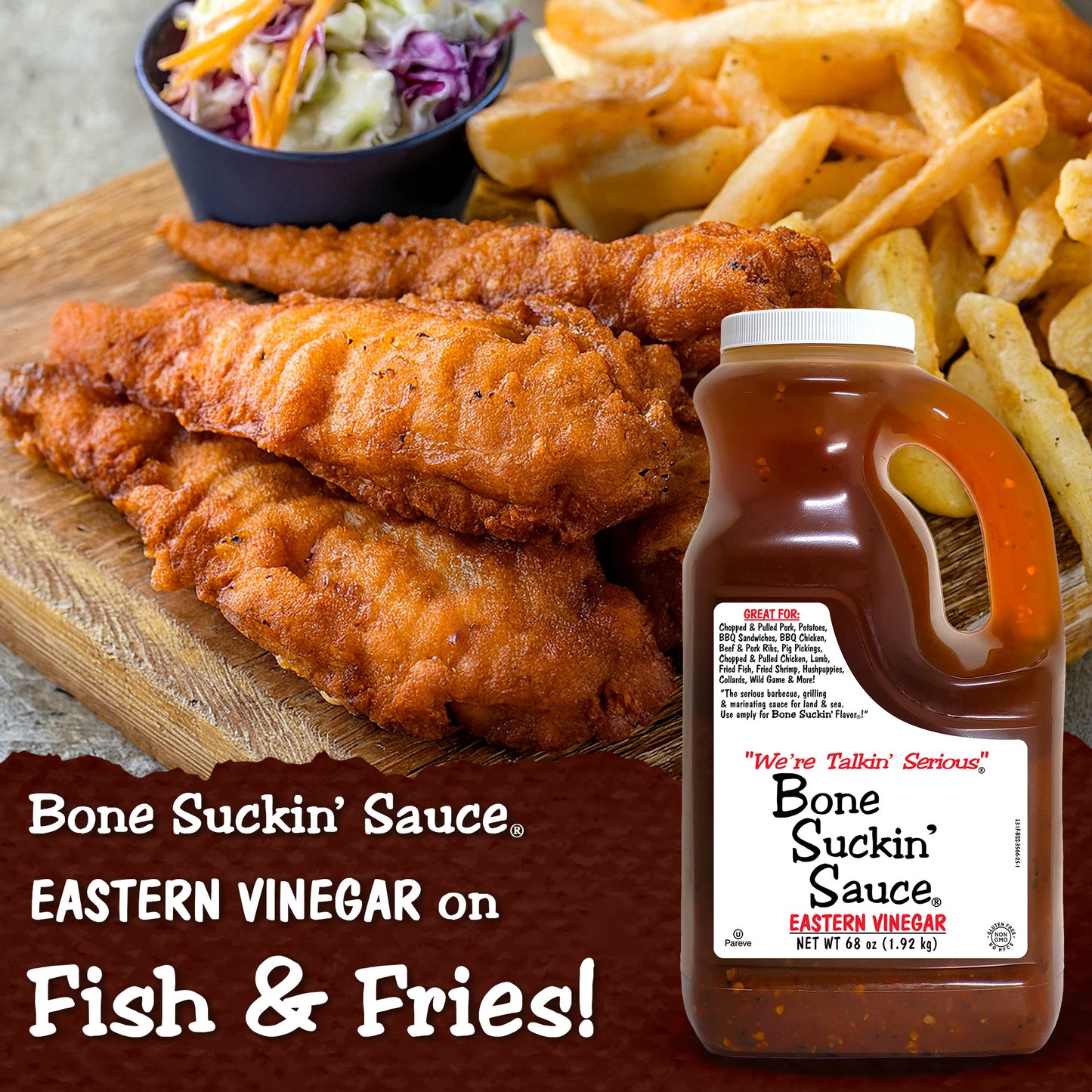 Fried fish and fries with a bottle of Bone Suckin' Sauce on a wooden board. - Bone Suckin' Sauce Eastern Vinegar on Fish & Fries!