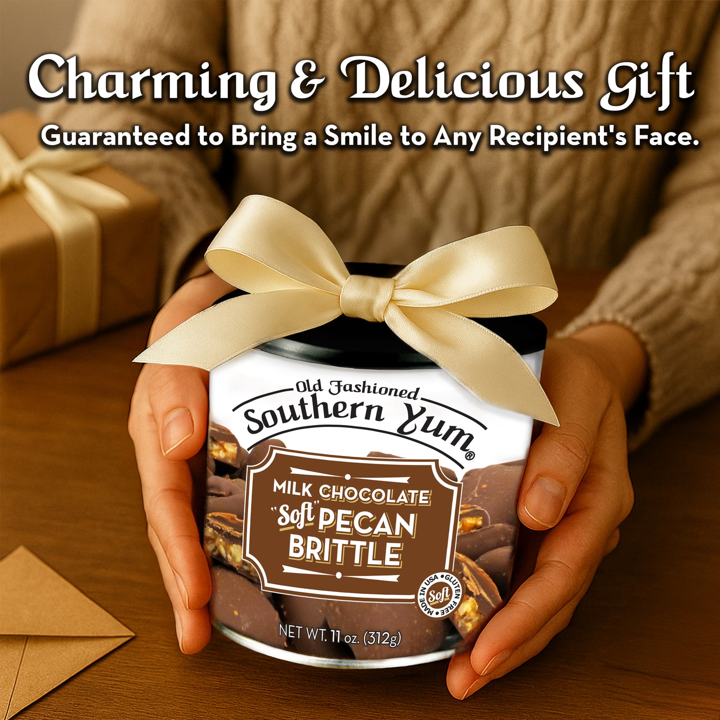 Jar of Old Fashioned Southern Yum Milk Chocolate Soft Pecan Brittle with a bow, held by hands on a wooden surface.