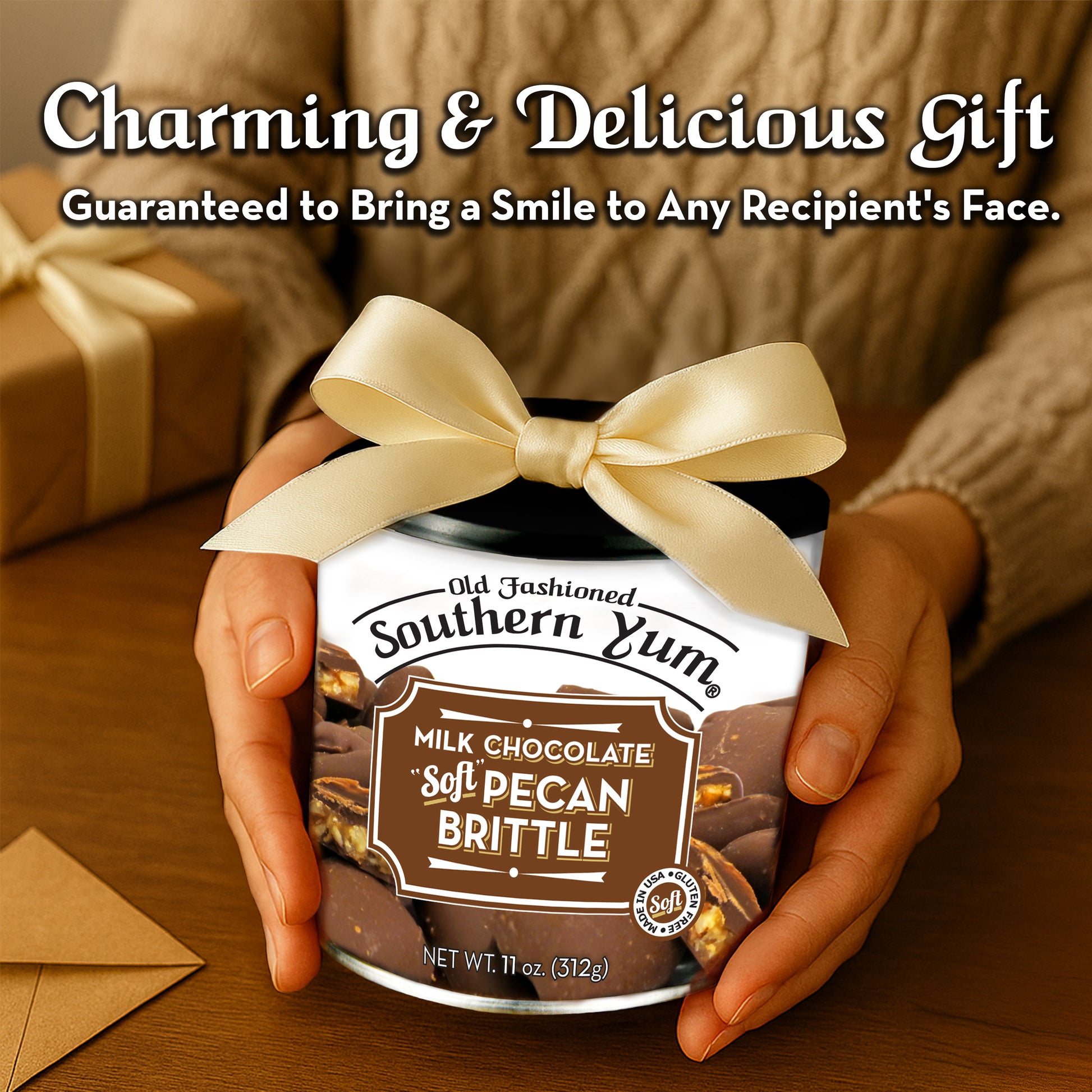Jar of Old Fashioned Southern Yum Milk Chocolate Soft Pecan Brittle with a bow, held by hands on a wooden surface.