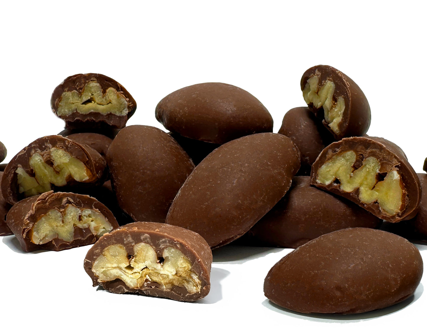 Southern Yum Butter Roasted Chocolate Pecans stacked on top of each other, some pieces cut in half showing the cross sections.