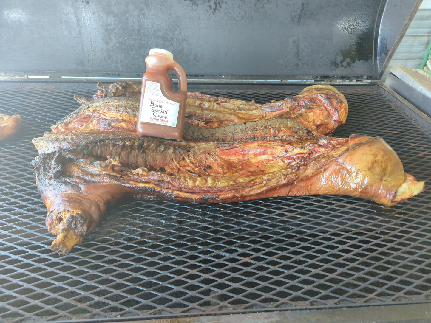 Grilled whole hog with Bone Suckin Eastern Vinegar Sauce