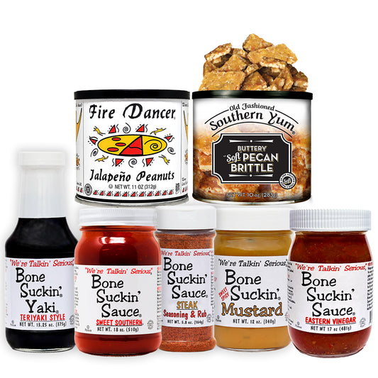 Collection of various food products including Fire Dancer jalapeño peanuts, Old Fashioned Southern Yum buttery soft pecan brittle, Bone Suckin' Sauce Sweet Southern, Bone Suckin' Sauce Eastern Vinegar, Bone Suckin' Steak Seasoning, Bone Suckin' Yaki, and Bone Suckin' Mustard.